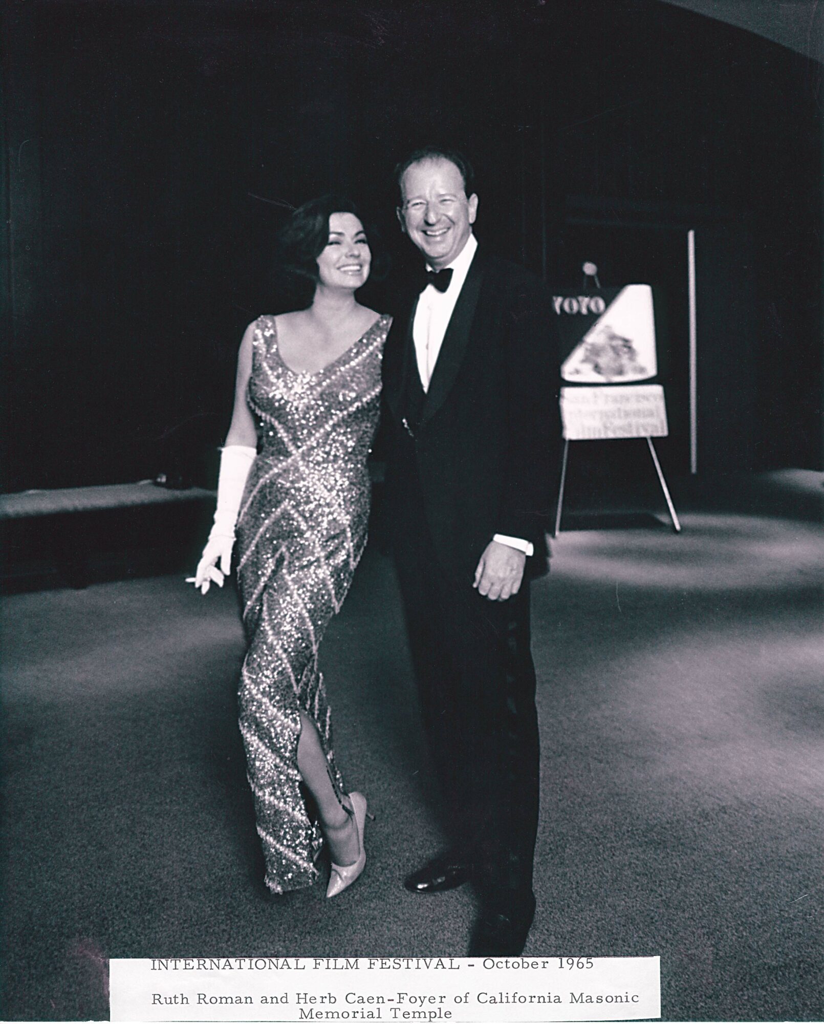 Chronicle columnist Herb Caen and actress Ruth Roman pose at the 1965 International Film Festival in the temple auditorium.