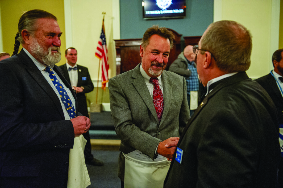 Tim Sands, left, and Steven Bodick, right, visit with Candidate Don Ales on Wednesday, November 9, 2022 at the Eureka Lodge No. 16 in Auburn, California.