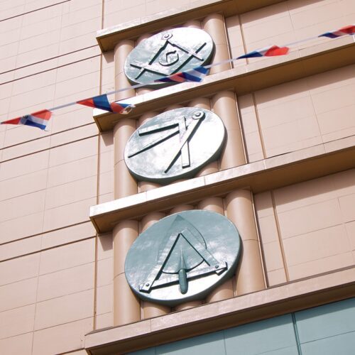 An expansion of the Mission Masonic Temple in the 1930s resulted in the installation of a new ceramic tile façade featuring three Masonic symbol medallions.