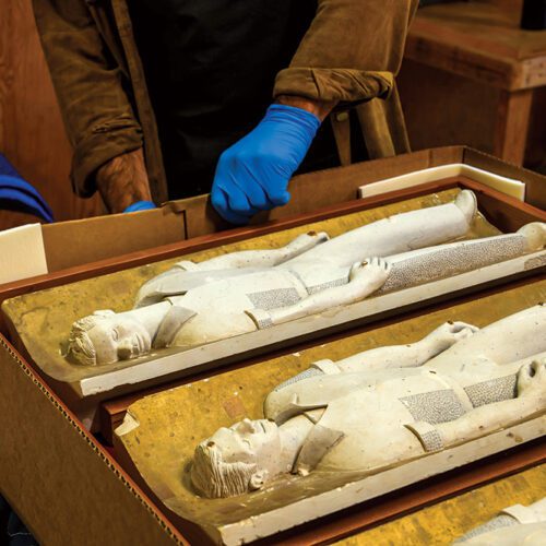 Workers box up the archives of artist Emile Norman in preparation of their move to the California Masonic Memorial Temple. Here, a maquette for the bas relief on the façade of the California Masonic Memorial Temple. Norman used several of his neighbors as models.