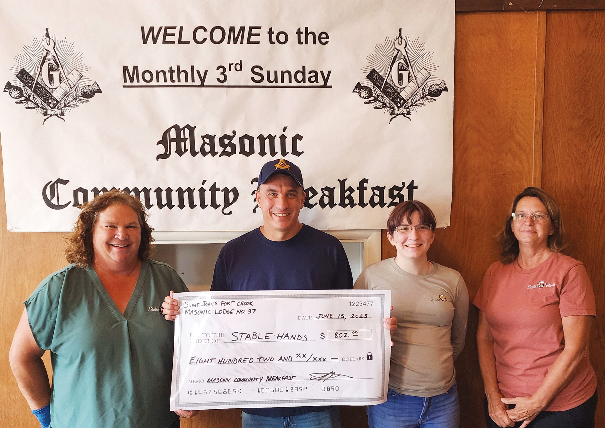 Lodge master Charles Bergman of St. John’s Fall Creek № 37 presents a check to a local charity during one of the lodge’s breakfast fundraiser events.